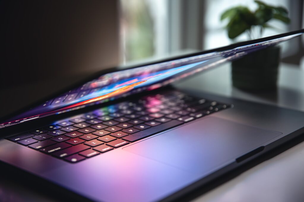 close up laptop keyboard colorful neon illumination backlit keyboard