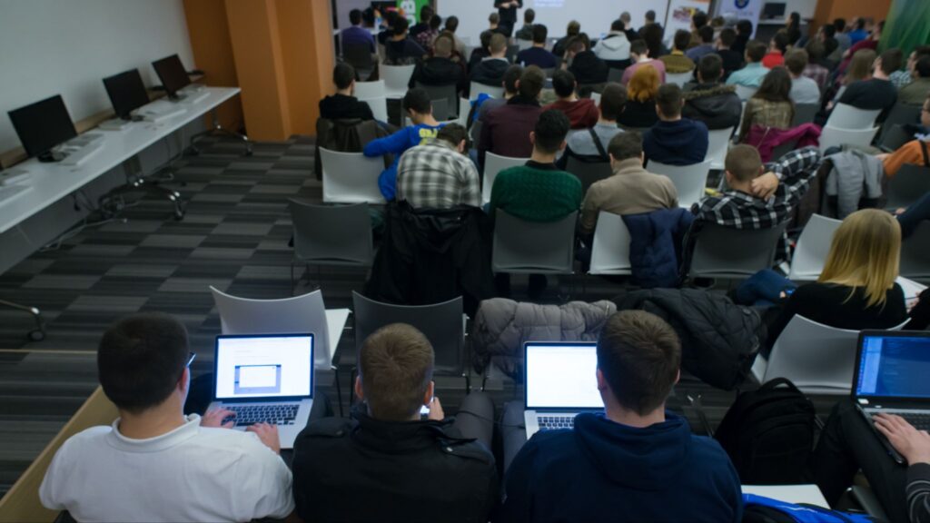 Attendees using rented laptops during a training session at a corporate event.
