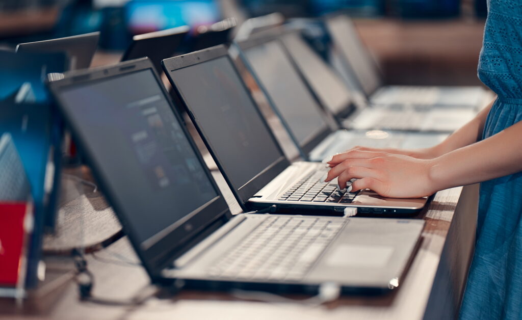young girl is testing laptop electronics store buying new laptop 1